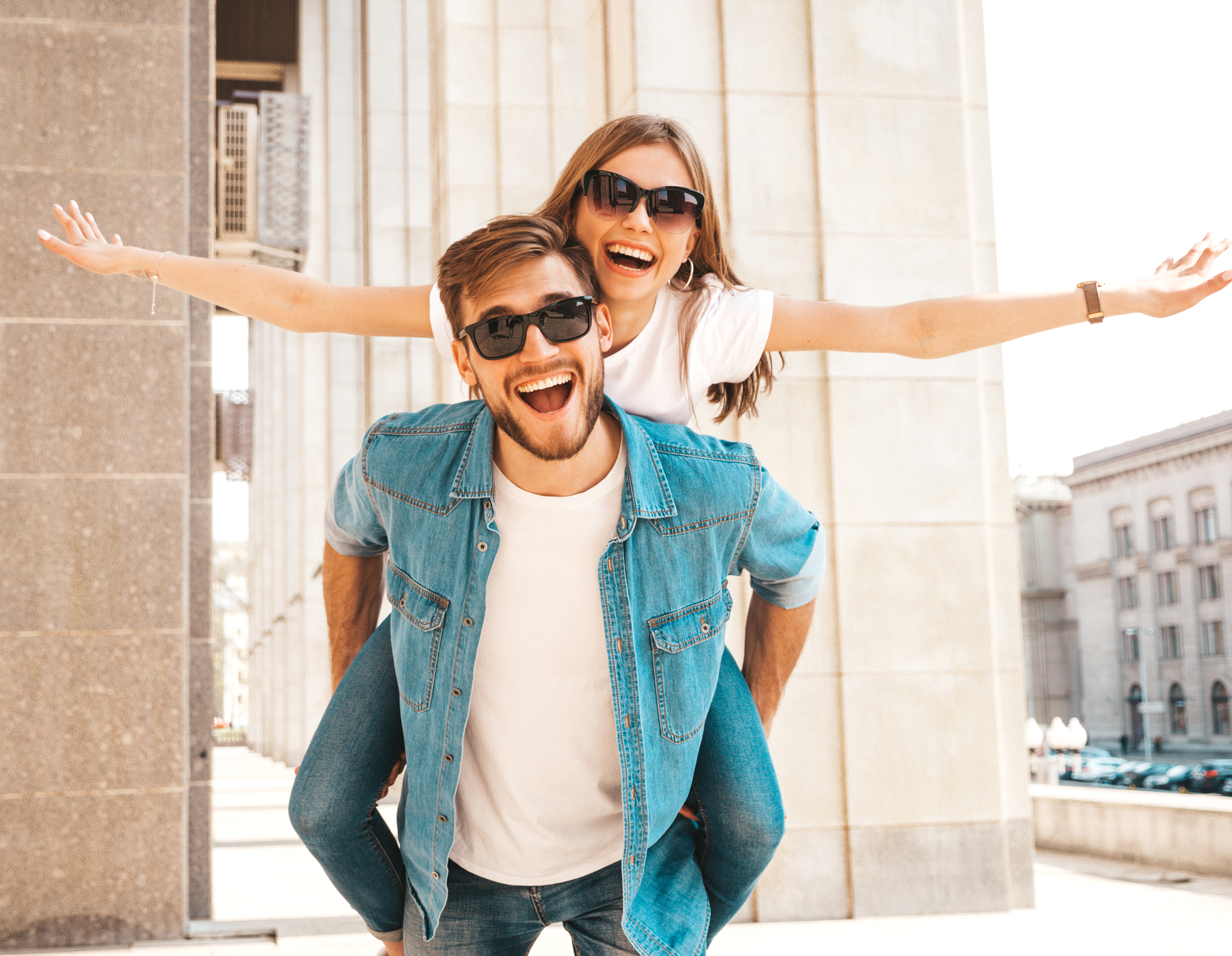 smiling-beautiful-girl-her-handsome-boyfriend-casual-summer-clothes-man-carrying-his-girlfriend-back-she-raising-her-hands (2)